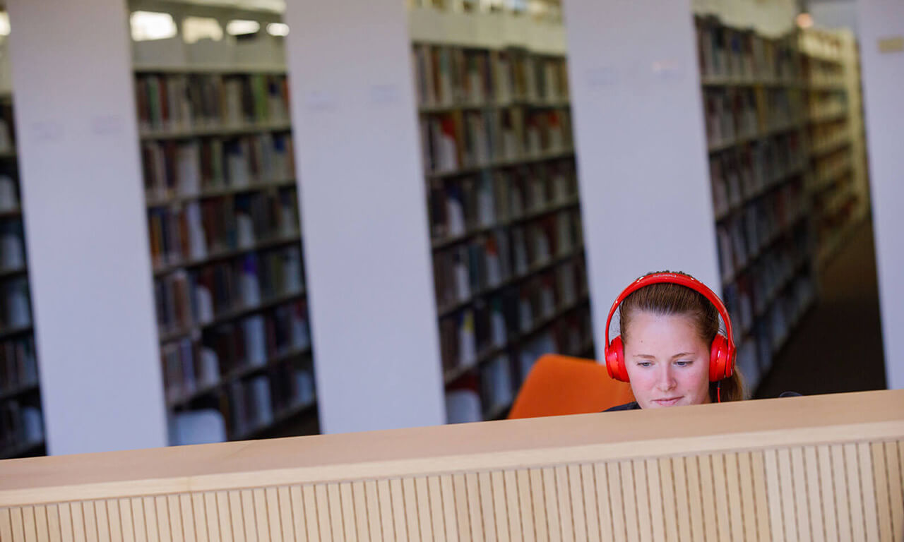 girl with headphones in the library